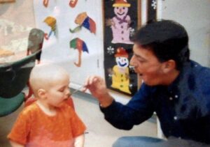 Hannah, in hospital as a child, being fed by her father