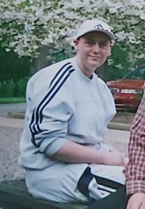 Marion McIntosh in a grey track suit and grey peaked cap