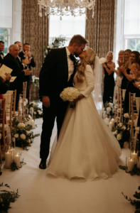 Iain and Maria on their wedding day, kissing in the aisle