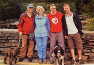 Raymond stood with his family outside with their two dogs