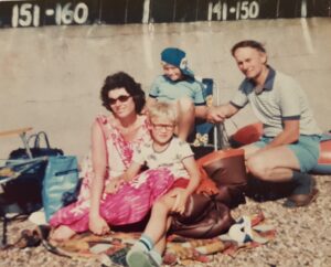 Raymond Clarke with sons and wife when they were younger on a beach