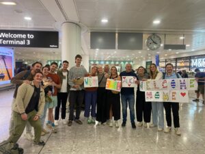Alice Bolton arriving back to the UK at Terminal 3 welcomed by friends and family holding signs