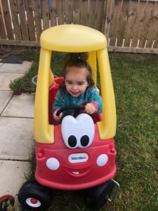 Summer outside on a little tikes push bike