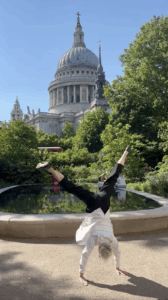 Lucy cartwheeling by St Pauls Cathedral