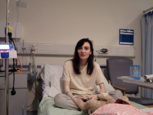 Ash sat in a hospital bed on the admission