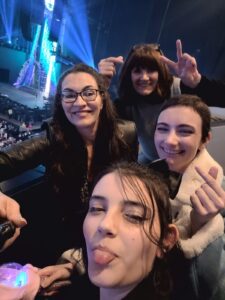 Ash with 3 others on a balcony at a concert in january 2025