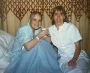 A patient smiling on a hospital bed