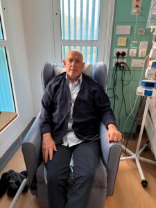 Paul sitting on a chair getting treatment