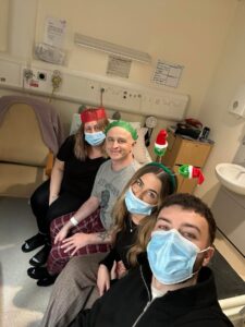 Clint in hospital with his wife, daughter Cora and her boyfriend